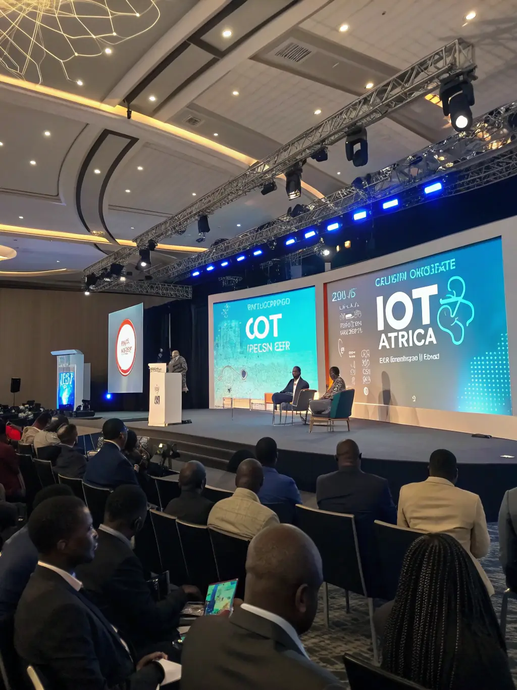A dynamic image of the IoT Forum Africa, featuring speakers presenting on stage and attendees interacting with IoT solutions.